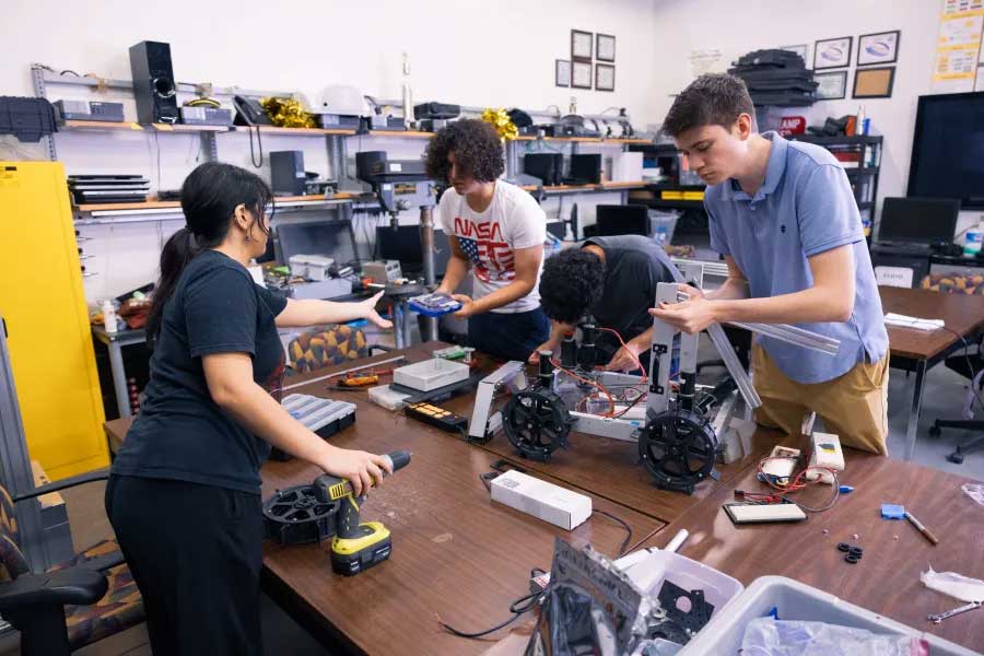 University students work on their Lunabot rover at NASA's Kennedy Space Center during the Lunabotics Challenge.